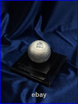 A spherical solid silver coin dedicated to Earth s satellite, the Moon