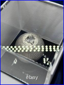 A spherical solid silver coin dedicated to Earth s satellite, the Moon